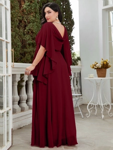 Detail view of burgundy chiffon plus size gown with cape sleeves and open back design