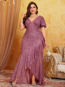 Detail of plus size sequin evening gown showing ruffled hem and magenta sparkles