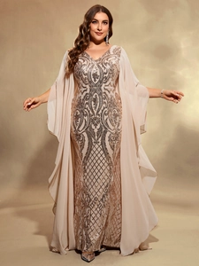 Detail of elegant champagne evening dress featuring sequin patterns and chiffon cape