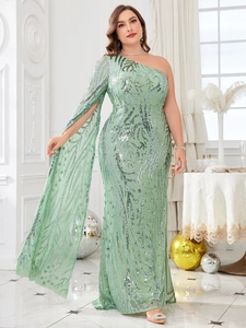 Detail of light green sequined gown with one-shoulder cape sleeve and glittery texture