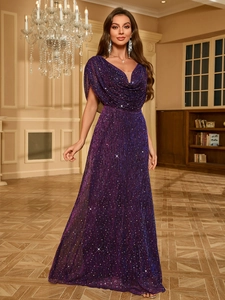 Detail of elegant dark purple evening dress featuring sparkling sequins and cape sleeves