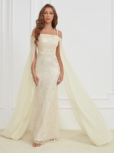 Close-up of champagne evening dress featuring sequin embroidery and sheer cape sleeves