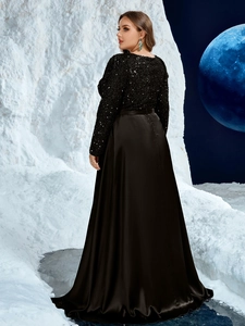 Detail of the elegant black evening dress featuring sequin bodice and satin floor-length skirt