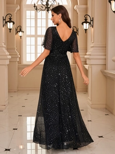 Detail view of the deep V-back design and sparkling silver sequins on this elegant evening gown