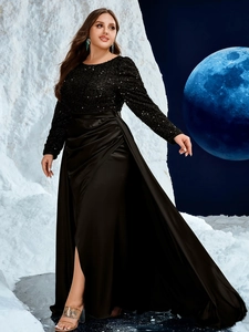 Detail showing the contrast between shiny black sequins and the smooth satin slit skirt