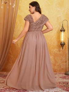 Detail of sequins on evening gown with V-back design and flowing chiffon skirt