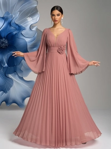 Detailed view of elegant pleated chiffon evening dress with floral waist decoration