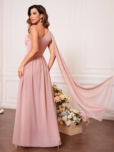 Détail d'une robe de soirée en mousseline rose à une épaule avec une manche cape fluide