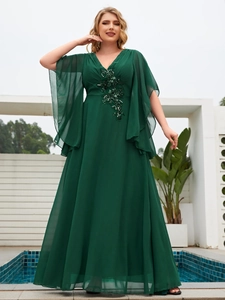 Detail of sequins and floral beadwork on dark green chiffon plus size evening gown