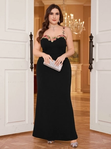 Close-up of intricate 3D floral embroidery on the neckline of a black plus size dress