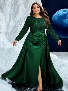 Detail of sequin bodice and emerald satin skirt with high slit on formal evening gown