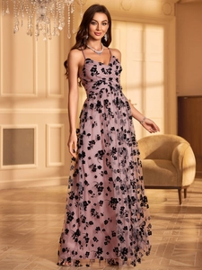 Detail of floral embroidery on a mesh evening gown with elegant V-neck and slim straps