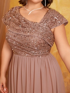 Detailed view of sequined pleated bodice and V-neck on an elegant chiffon maxi dress
