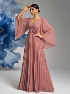 Detail of elegant V-neck chiffon gown featuring pleated skirt and floral waist embellishments