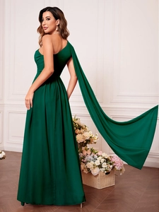 Détail d'une robe de soirée asymétrique vert foncé avec une longue écharpe en mousseline