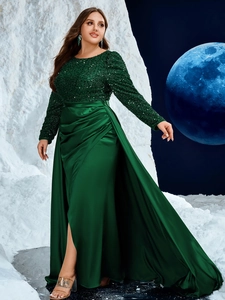 Close-up of emerald green satin evening gown featuring sparkling sequin bodice details