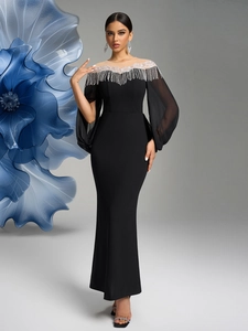 Detail of the elegant black evening gown with beaded embroidery and fringe tassels