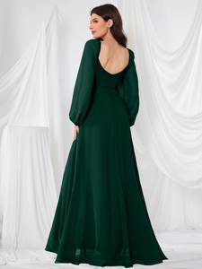 Detailed back view of a dark green backless long-sleeve chiffon evening gown with hidden zipper