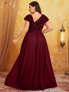 Detail of burgundy maxi dress featuring a V-back design and sparkling sequin top bodice