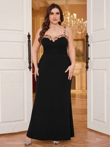 Detail of floral embroidery on a black plus size bodycon dress with spaghetti straps