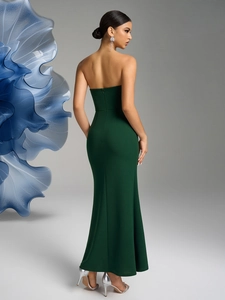 Detailed back view of a slim-fit dark green evening gown with invisible zipper and slit