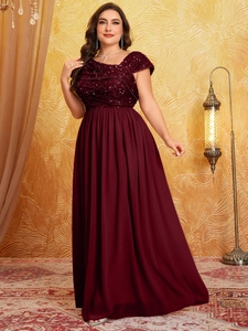 Macro detail of wine red sequin bodice and pleated chiffon fabric on luxury evening gown