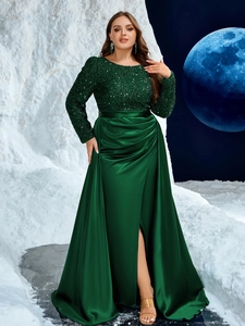 Detail of sequin bodice and high-slit satin skirt on elegant dark green evening gown
