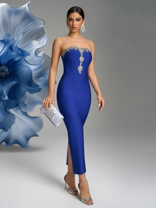 Detail of royal blue strapless dress featuring intricate rhinestone beadwork and side slit