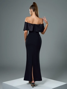 Rear view of elegant black off-shoulder evening gown with fishtail hem and back slit detail