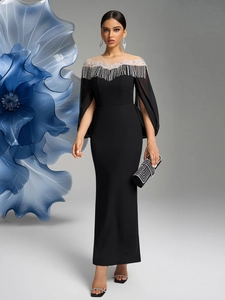 Detail of elegant black gown with sequined fringe neckline and slit cape sleeves