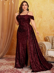 Detail of burgundy sequin evening gown showing slit hem and shimmering fabric texture