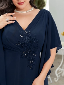 Detail of navy blue V-neck chiffon gown with sequined floral lace and ruffled sleeves