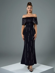 Detail of off-shoulder neckline with black satin trim and sparkling rhinestone patterns