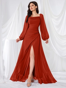 Detail of rust red chiffon evening dress with square neckline and pleated draped waist