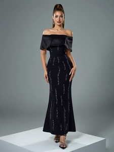 Macro shot of off-shoulder neckline and sparkling silver rhinestones on black evening gown