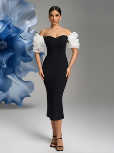 Detail of artistic white floral ruffled sleeves on a slim-fit black off-shoulder evening dress