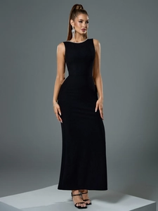 Close-up of elegant black backless fishtail dress with white pearl beaded neckline