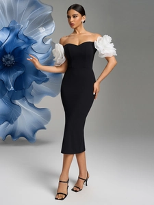 Detail of elegant off-shoulder black dress with oversized white 3D floral sleeves decoration