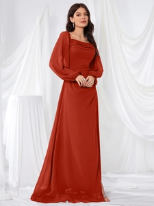 Detailed view of the square neckline and pleated chiffon texture on rust red dress
