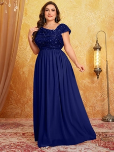 Close-up of shimmering navy blue sequin bodice and pleated chiffon hemline on evening gown