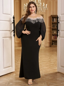 Detail of elegant black evening gown featuring silver sequins and fringe on the neckline