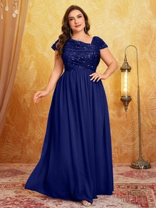 Detail of navy blue plus size evening gown featuring sequined bodice and flowing chiffon skirt