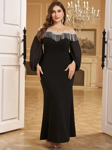 Close-up of elegant silver fringe sequins and mesh detailing on a black evening gown