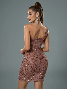 Detailed close-up showing back view of rose gold sequin dress with backless design
