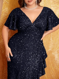 Close-up of sparkling navy blue sequins and elegant ruffle sleeves on a V-neck evening gown