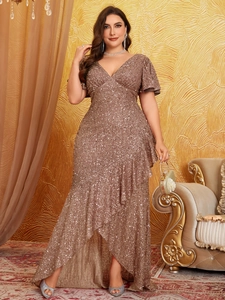 Close-up of sparkling sequin evening gown featuring V-neck and tiered high-low hem design
