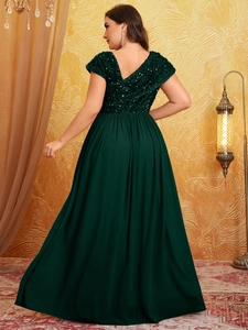 Detail of dark green plus size evening gown with sequined V-neck bodice and long skirt