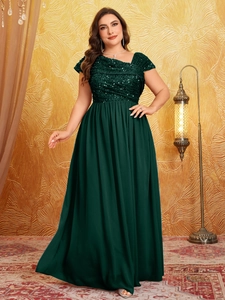 Detail of sequined bodice and pleated chiffon skirt on a dark green evening gown