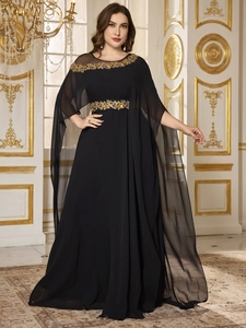Detail showing golden sequin flower embroidery on the neckline and waist of black chiffon gown
