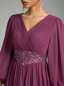 Détail de la robe en mousseline à col en V avec bustier plissé et taille pailletée